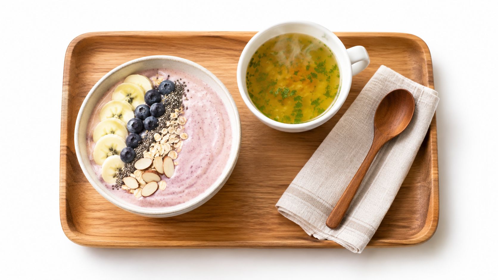 A healthy breakfast bowl with fruit and soup on a wooden tray for soft food diet recovery